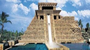 A large pyramid structure with a water slide leading into a clear pool. - Vacation Rental Villa sleeps 4;Harborside Resort at Atlantis, Bahamas; Dec16-21 (Paradise Island)
