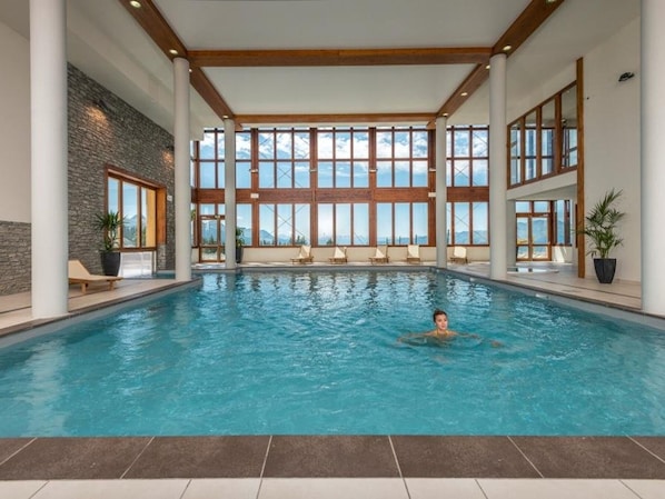 Relax by the pool surrounded by lush views and comfortable lounge chairs.