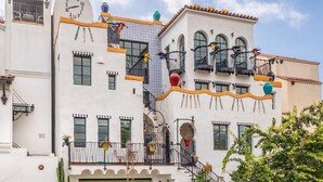 A multi-story building with balconies, a clock, and decorative elements. - Iconic, Unique Home in the Heart of Downtown SB! (Santa Barbara)