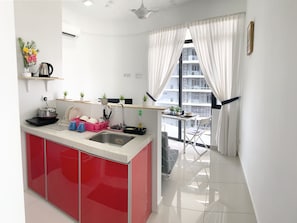 Full-sized fridge, stovetop, cookware/dishes/utensils, cleaning supplies