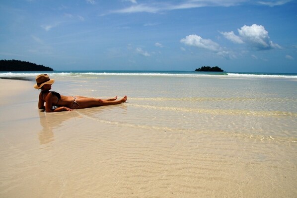 On the beach, white sand, beach towels