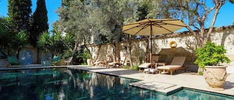 Outdoor pool, open 6:00 AM to 9:00 PM, pool umbrellas, pool loungers