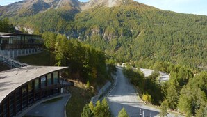A mountain road with a building on the left.