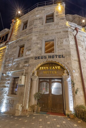 A stone building with the sign "Zeus Hotel" and "Zeus Cave Suites" indicating a hotel with a cave-themed suite. - Zeus Cave Suites (Nevsehir)