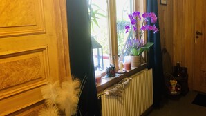 A room with a window, a radiator, and a teddy bear on a chair. - 2-bed Apartment Overlooking the River (Avesta)
