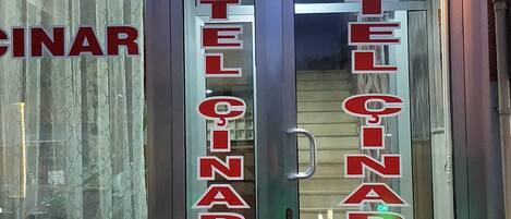 The exterior of the Cinar Hotel with a prominent illuminated sign above the entrance.