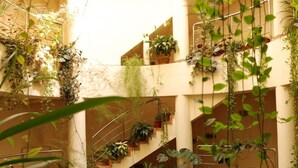 A multi-level atrium with vertical gardens and staircases. - Hotel Gallant (Sibiu)