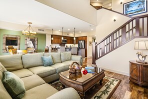 Relax in this inviting living area with a comfortable sectional sofa, matching armchair, and a stylish coffee table.