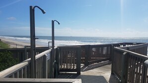 A wooden boardwalk leading to a beach with a clear view of the ocean. - Oceanfront Escape - Private Beach Access – Pool – Spacious Balcony – Sleeps 6 (North Topsail Beach)