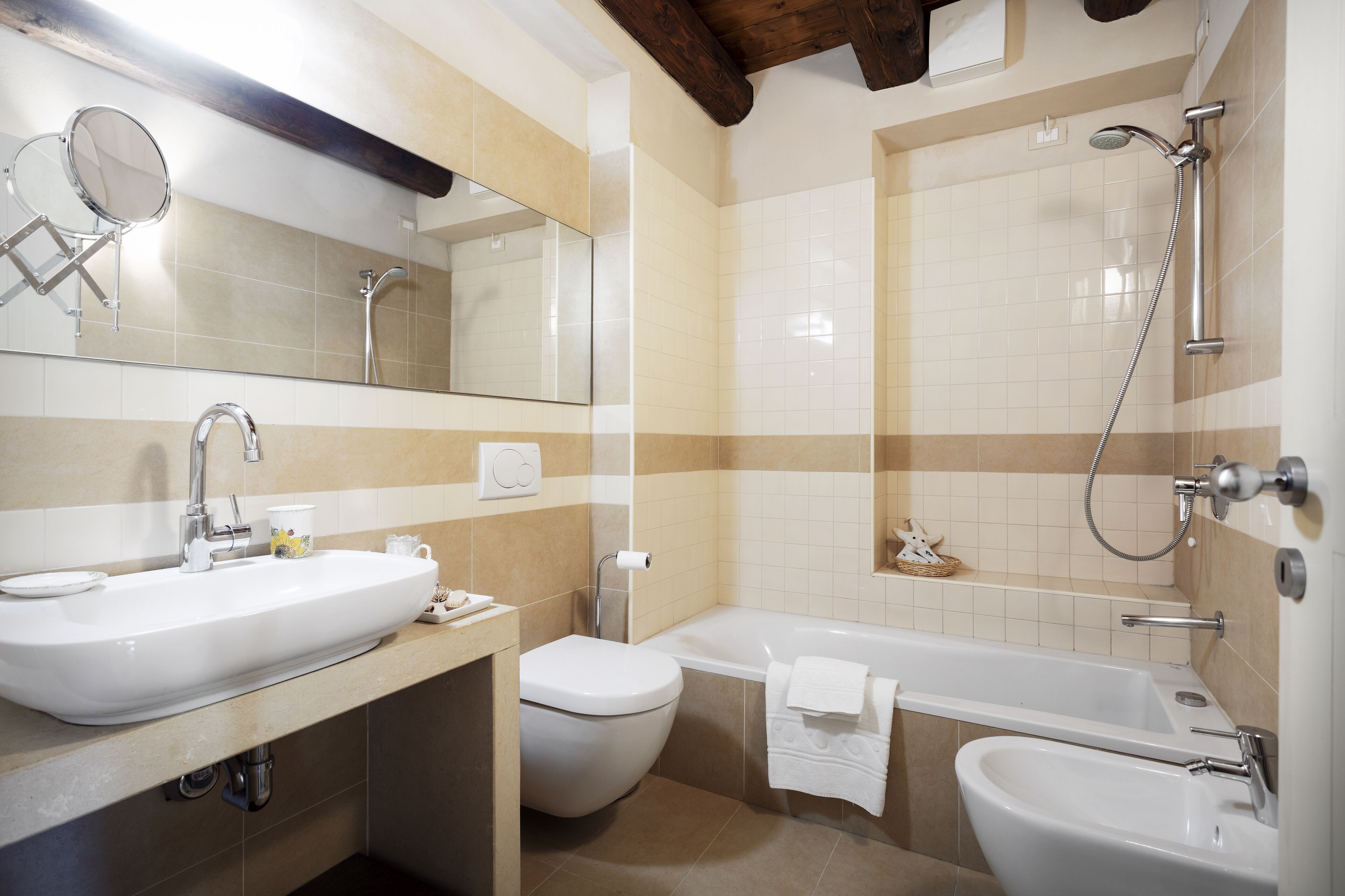 A bathroom with a sink, toilet, bathtub, and shower.