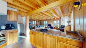 Une cuisine spacieuse avec des meubles en bois, un plan de travail en granit et un grand îlot central.