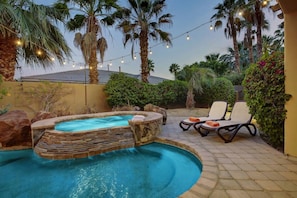 A pool area with a hot tub, lounge chairs, and string lights. - Tuscany: Pool, Spa, Fire Pit, Ping Pong Games (Indio)