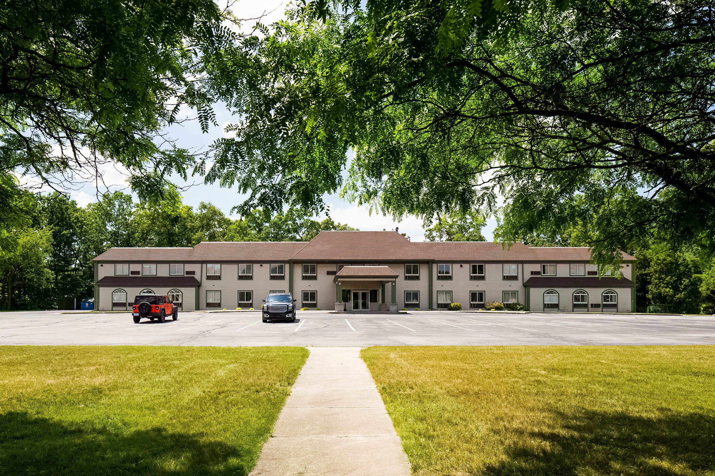 A two-story building with a parking lot in front.