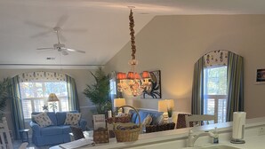 A spacious kitchen with a central island, white cabinetry, and a dining area with blue furniture. - Need to get away ... Cabin fever got you down. Take a trip to Pawleys Island, SC (Pawleys Island)