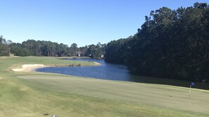 A golf course with a water hazard, a flag, and a white fence. - Need to get away ... Cabin fever got you down. Take a trip to Pawleys Island, SC (Pawleys Island)