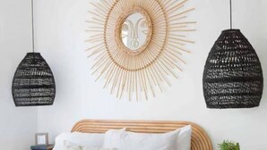 A bedroom with a wooden bed, white bedding, a large mirror, and two hanging light fixtures. - Luxury Rental - Historic Charm - Central Location! (Charleston)