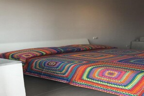 A bed with a colorful, patterned blanket.