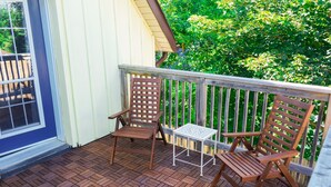 A wooden deck with two chairs and a small table. - Walk to Downtown or conservation area, 2 Bedroom home . Sleeps 4. Pets welcomed (Orangeville)