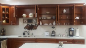 A kitchen with wooden cabinets, a sink, a coffee maker, and a blender. - Jazzy Escapes (with pool) near Hard Rock Stadium (Miami)