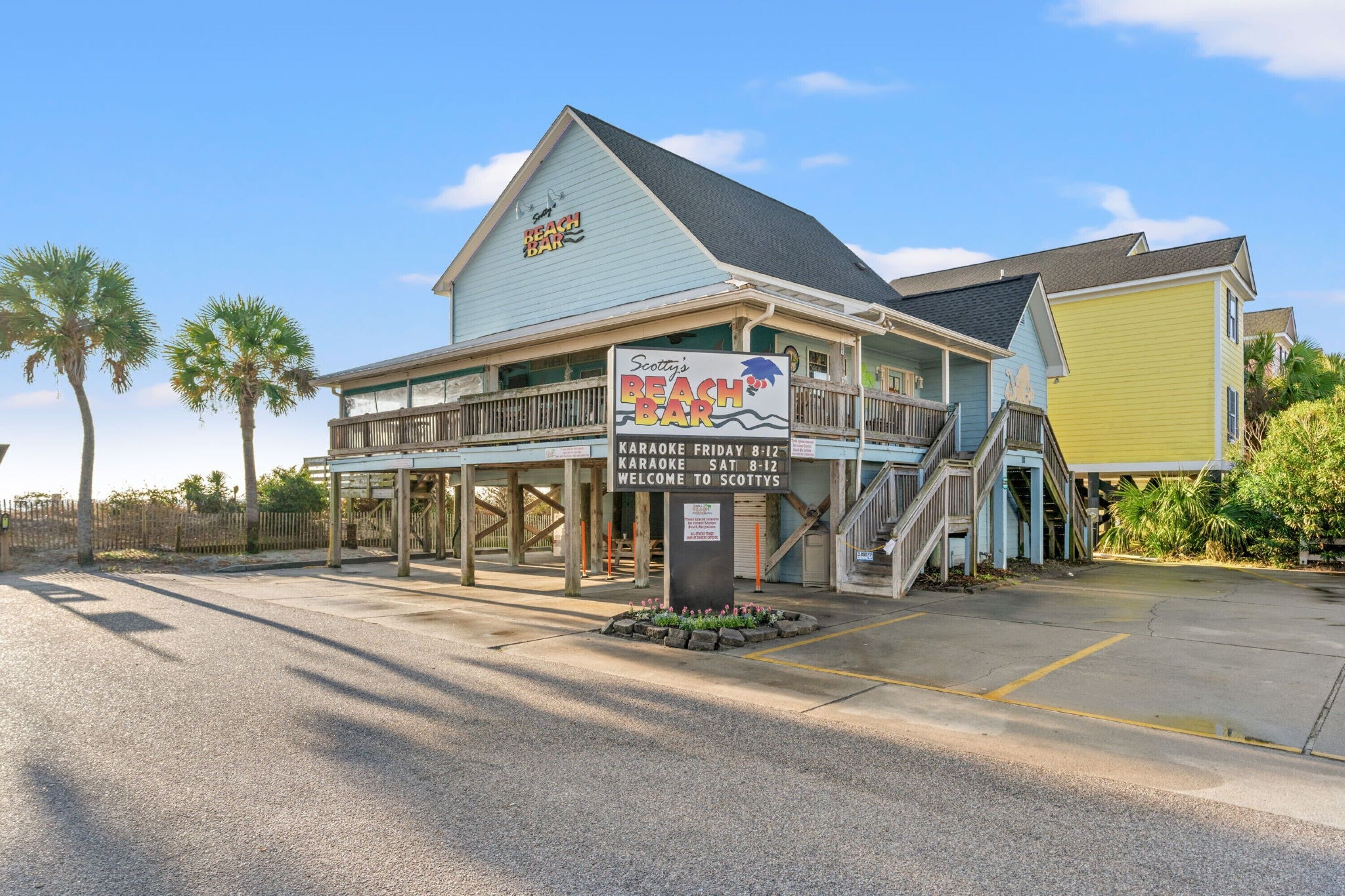 A beach bar with a sign advertising karaoke on Fridays and Saturdays.