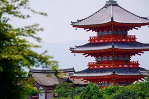 A traditional multi-tiered pagoda with red and white accents, surrounded by lush greenery. - D6 1 minute walk from Karasuma Oike Station Grea - Karasuma Annex 416 / Kyoto Kyōto (Kyoto)