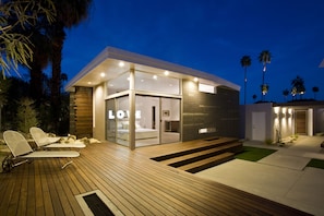 Relax in a stylish home with a spacious bedroom, large window, and deck.
