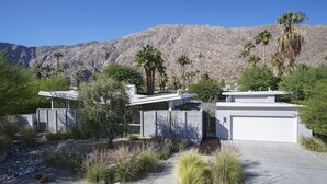 A modern house with a garage, surrounded by desert vegetation and mountains. - The Butterfly 4 Bedroom Home, Ideal Downtown Historic Tennis Club location (Palm Springs)