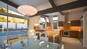 A modern kitchen with a large island, built-in oven, and stainless steel appliances. - The Butterfly 4 Bedroom Home, Ideal Downtown Historic Tennis Club location (Palm Springs)