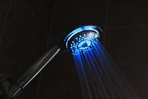 A showerhead with blue LED lights. - Beautifully Designed Oasis - Blocks to UF Stadium! (Gainesville)