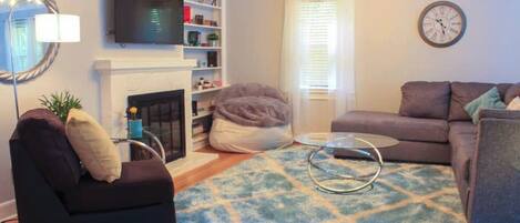 Smart TV, fireplace, books, smart speakers