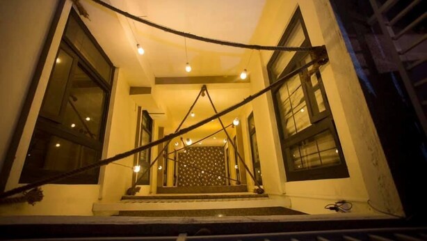 A staircase with a metal railing, leading to a landing with a patterned wall. - Hotel Tryst (Bhaktapur)