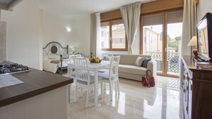 Una sala de estar moderna con comedor, sofá y televisor.