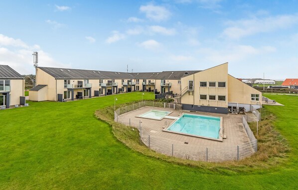 Guests can enjoy a refreshing swim in the pool surrounded by a spacious deck.