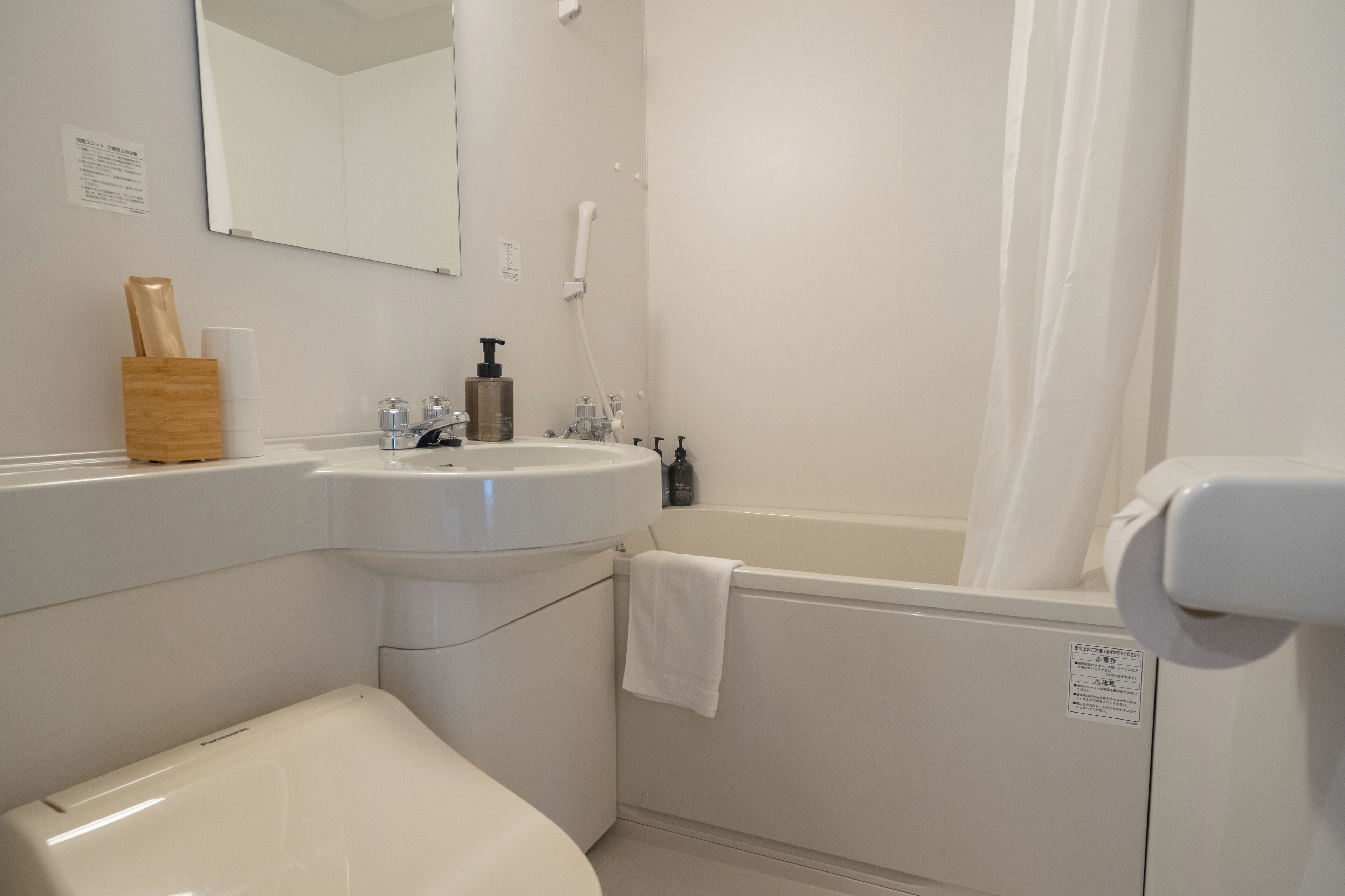 refined designer twin/triple (non-smoking) | bathroom | combined shower/bathtub, eco-friendly toiletries, hair dryer, slippers