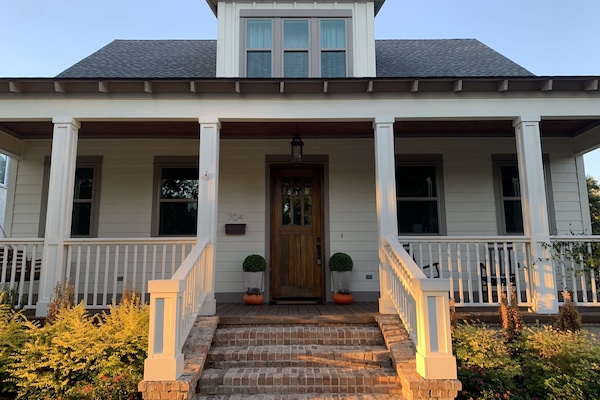 Front of house with porch, swing, and rocking chairs
