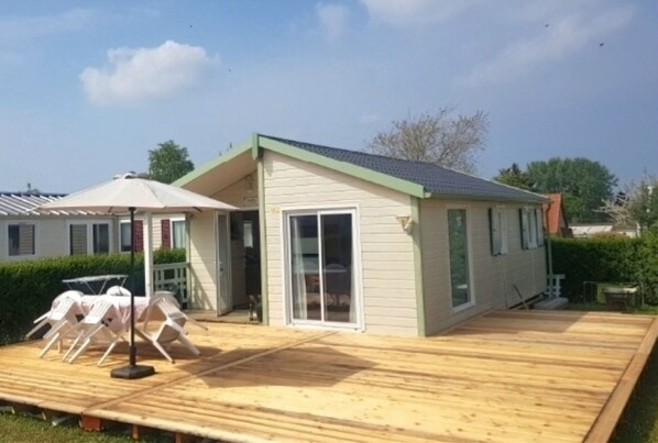 Enjoy a relaxing stay in this charming single-story home with a spacious porch and comfortable seating area.