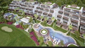 Een modern wooncomplex met meerdere flatgebouwen, een centraal aangelegd gebied met een fontein en omliggend groen.