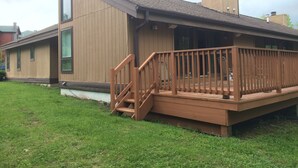 A modern house with a wooden deck and a small staircase leading to a covered porch. - Hunter Townhouse - walk to slopes!  Ski Seasonal Rental - 3BR/3BA.  Private (Hunter)