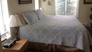 A bedroom with a bed, a bedside table with a lamp, a clock, and a window with curtains. - Hunter Townhouse - walk to slopes!  Ski Seasonal Rental - 3BR/3BA.  Private (Hunter)