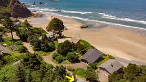 A coastal residential area with houses, a beach, and rocky outcrops. - hot tub, ocean views and wood burning fireplace (Tillamook)