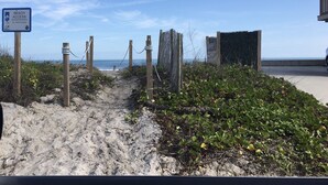 A beach access sign in St. Johns County, a sandy path leading to the beach, and a wooden fence. -  Summer in Vilano Beach, St. Augustine with awesome Sunsets (St. Augustine)