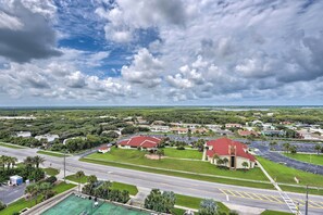 An aerial view of a residential area with houses, a church, and a road. - Beachfront Resort Condo w/ Panoramic Ocean Views! (New Smyrna Beach)