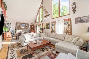 Relax in this spacious living area with a large L-shaped sofa and stone fireplace.