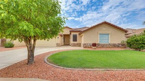 A house with a stone foundation, a front door, and a small front yard with a tree and a well-maintained lawn. - 4 Mi to Riparian Preserve: Mesa Abode w/ Hot Tub (Mesa)