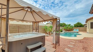 A hot tub under a canopy, a swimming pool, and a patio area with steps and chairs. - 4 Mi to Riparian Preserve: Mesa Abode w/ Hot Tub (Mesa)