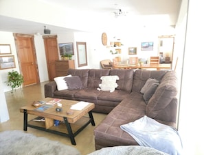 Relax in this inviting living space with a comfortable sofa, coffee table, and dining area.