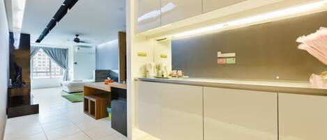 A modern kitchen with a built-in island, white cabinets, and a bright overhead light.