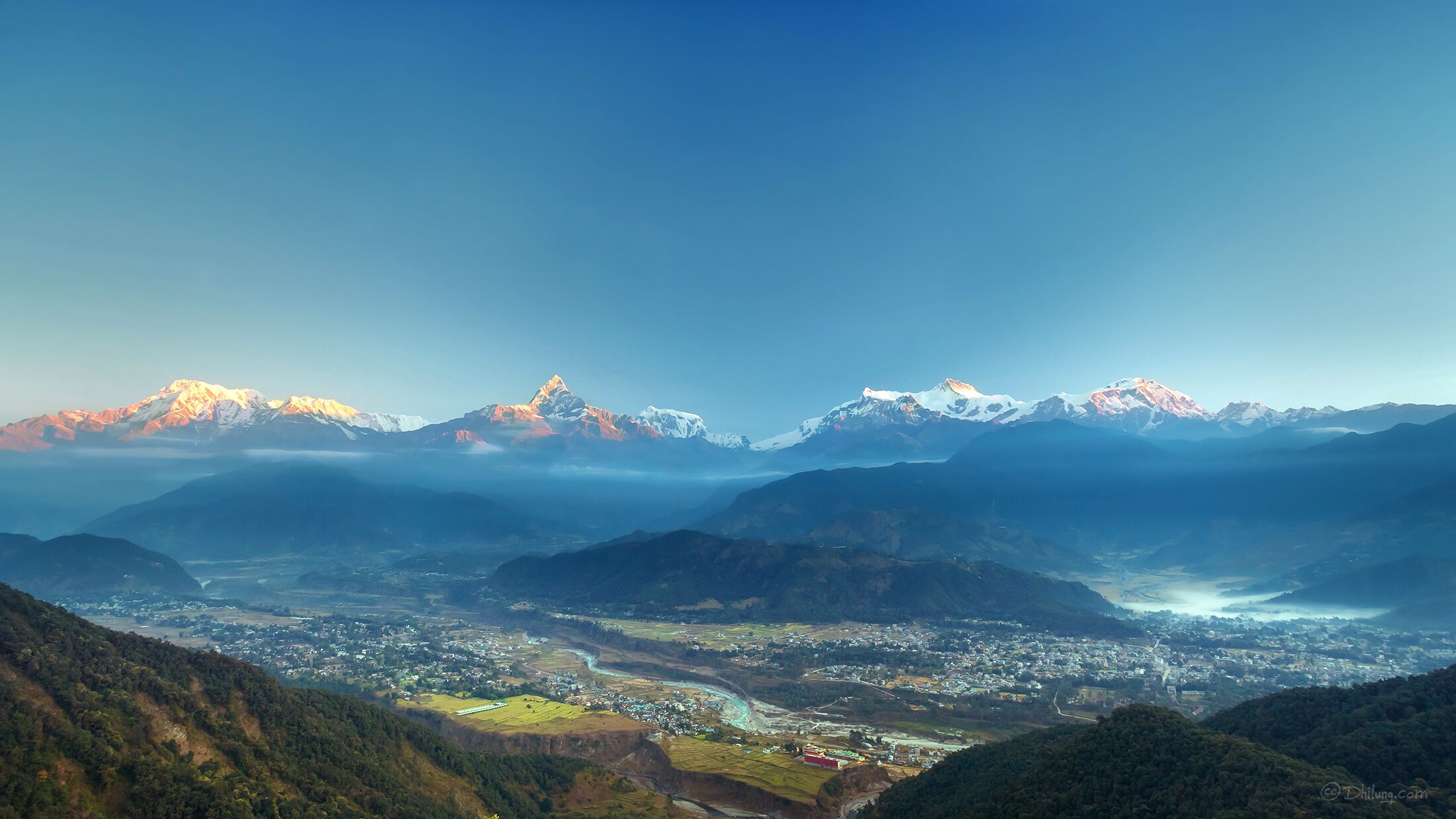A mountainous landscape with a town nestled in the valley.