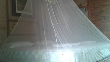 A bed with a mosquito net.