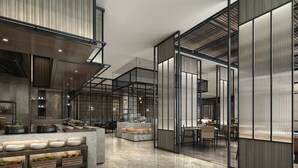 Un hall d’hôtel moderne doté d’un comptoir d’accueil central, d’espaces de détente et d’un grand espace ouvert avec de hauts plafonds et une abondance de lumière naturelle.